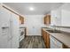 Well-lit kitchen featuring light countertops, wood cabinets, and appliances at 4144 N 109Th Ave, Phoenix, AZ 85037