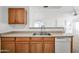 Kitchen featuring wood cabinets and a stainless steel double sink at 4144 N 109Th Ave, Phoenix, AZ 85037