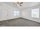 Bright living room with neutral carpet, a ceiling fan, and windows providing ample natural light at 4144 N 109Th Ave, Phoenix, AZ 85037