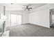 Spacious living room with modern ceiling fan and sliding door for natural light at 4144 N 109Th Ave, Phoenix, AZ 85037