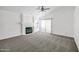 Open-concept living room featuring a fireplace, and sliding glass doors providing ample light at 4144 N 109Th Ave, Phoenix, AZ 85037