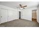 Bright main bedroom with a ceiling fan and closet with sliding doors at 4144 N 109Th Ave, Phoenix, AZ 85037