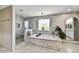 Bathroom featuring a large tub, tiled walls, and a separate shower at 4243 E Avalon Dr, Phoenix, AZ 85018