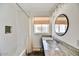 Bathroom with bathtub and shower, sink with granite countertop and round mirror at 4243 E Avalon Dr, Phoenix, AZ 85018