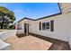 View of a stone-tiled front porch with an American flag, leading to a light-filled home at 4243 E Avalon Dr, Phoenix, AZ 85018