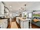 Open-concept kitchen featuring a marble island with seating, stainless appliances, and modern lighting at 4243 E Avalon Dr, Phoenix, AZ 85018