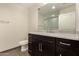 Modern bathroom featuring granite countertop vanity and a walk-in shower in the background at 4803 N Woodmere Fairway -- # 1002, Scottsdale, AZ 85251