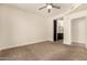 Bright bedroom featuring a ceiling fan and attached bathroom for added convenience at 4803 N Woodmere Fairway -- # 1002, Scottsdale, AZ 85251