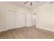 Bedroom with large closet space featuring sliding doors and a ceiling fan for added comfort at 4803 N Woodmere Fairway -- # 1002, Scottsdale, AZ 85251