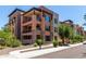 Exterior of a multi-story condo with stone accents and private balconies, showcasing modern design at 4803 N Woodmere Fairway -- # 1002, Scottsdale, AZ 85251