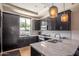 Kitchen with dark cabinets, granite countertops, and stainless steel appliances at 4803 N Woodmere Fairway -- # 1002, Scottsdale, AZ 85251