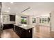 Bright, open kitchen with granite countertops, hardwood floors, and an adjacent living area at 4803 N Woodmere Fairway -- # 1002, Scottsdale, AZ 85251