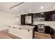 Modern kitchen with stainless steel appliances, granite countertops, and dark wood cabinetry at 4803 N Woodmere Fairway -- # 1002, Scottsdale, AZ 85251