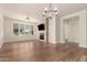 Bright, open living room featuring hardwood floors, large windows, and a stylish fireplace at 4803 N Woodmere Fairway -- # 1002, Scottsdale, AZ 85251