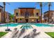 Beautiful blue community pool and hot tub with upscale condo building in background at 4803 N Woodmere Fairway -- # 1002, Scottsdale, AZ 85251