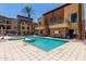 Well-maintained community pool with multiple condo buildings in the background at 4803 N Woodmere Fairway -- # 1002, Scottsdale, AZ 85251