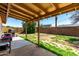 Covered patio with barbecue in a spacious backyard with block fence at 4845 W Sweetwater Ave, Glendale, AZ 85304