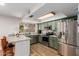 Kitchen featuring granite countertops, stainless appliances, and window with plants at 4845 W Sweetwater Ave, Glendale, AZ 85304