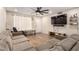 A living room featuring hardwood floors, a sectional, and a large fan at 4845 W Sweetwater Ave, Glendale, AZ 85304