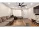 A living room featuring hardwood floors, a sectional, and a large fan at 4845 W Sweetwater Ave, Glendale, AZ 85304