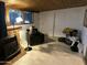 Finished basement featuring a wood burning stove, tile floors, and a sitting area at 5735 N 32Nd Dr, Phoenix, AZ 85017