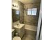 Updated bathroom with shower-tub combo, marble-look tile and updated vanity at 5735 N 32Nd Dr, Phoenix, AZ 85017