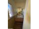 Compact bathroom features a vanity sink, a large mirror, new vinyl flooring, and a natural light at 5735 N 32Nd Dr, Phoenix, AZ 85017