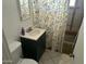 Small bathroom with a sink, toilet, and leaf-themed shower curtain at 5735 N 32Nd Dr, Phoenix, AZ 85017