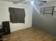 A simple bedroom with hardwood floors and neutral walls at 5735 N 32Nd Dr, Phoenix, AZ 85017