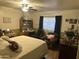 Bedroom with a ceiling fan, bed, chair, and desk area, creating a cozy space at 5735 N 32Nd Dr, Phoenix, AZ 85017