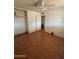 Bedroom featuring hardwood floors, ceiling fan, and closet space at 5735 N 32Nd Dr, Phoenix, AZ 85017