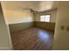 A quaint bedroom featuring new vinyl floors, a ceiling fan, and plenty of natural light at 5735 N 32Nd Dr, Phoenix, AZ 85017