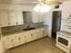 Traditional kitchen with white cabinetry, light countertops, and tile flooring at 5735 N 32Nd Dr, Phoenix, AZ 85017