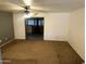 Spacious living room with a ceiling fan and doorway access to a room with a fireplace at 5735 N 32Nd Dr, Phoenix, AZ 85017