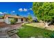 Expansive backyard with a well-manicured lawn, mature trees, and a large patio area, perfect for outdoor gatherings at 5803 W John Cabot Rd, Glendale, AZ 85308