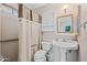 Cozy bathroom with updated vanity, shower with a curtain, and grab bars for easy accessibility at 5803 W John Cabot Rd, Glendale, AZ 85308