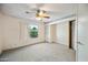 Bright bedroom with a ceiling fan, closet, and a window offering natural light and a pleasant view at 5803 W John Cabot Rd, Glendale, AZ 85308