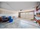 Spacious garage with ample room for parking and storage, featuring a white door and unfinished drywall at 5803 W John Cabot Rd, Glendale, AZ 85308