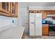 The kitchen features a refrigerator, stainless steel appliances, wood cabinets, and ample counter space at 5803 W John Cabot Rd, Glendale, AZ 85308