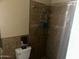 Cozy bathroom with tiled shower, toilet, and a functional layout at 61 W 11Th Dr, Mesa, AZ 85210