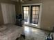 Bright bedroom featuring tiled floors, closet and light coming through the windowed french doors at 61 W 11Th Dr, Mesa, AZ 85210