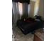 Bedroom with a dark bedspread, tile floors and bright natural light from the window at 61 W 11Th Dr, Mesa, AZ 85210