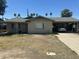 A cozy single-story home with a carport, desert landscaping, and a charming, sun-drenched facade at 61 W 11Th Dr, Mesa, AZ 85210