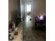 Hallway with functional dresser and decor leading to brightly lit back of the house at 61 W 11Th Dr, Mesa, AZ 85210