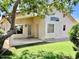 Inviting backyard featuring a covered patio area and mature greenery for privacy at 6376 W Adobe Dr, Glendale, AZ 85308