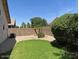 Green backyard features mature trees, rock beds, and privacy wall at 6376 W Adobe Dr, Glendale, AZ 85308