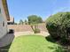 Well-kept backyard with a small grassy area, desert landscaping, and a block wall at 6376 W Adobe Dr, Glendale, AZ 85308