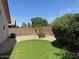 Green backyard features mature trees, rock beds, and privacy wall at 6376 W Adobe Dr, Glendale, AZ 85308