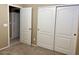 Bedroom boasts neutral carpet and closet with double doors at 6376 W Adobe Dr, Glendale, AZ 85308
