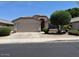Single-story home with a two-car garage, desert landscaping, and a terracotta tile roof at 6376 W Adobe Dr, Glendale, AZ 85308